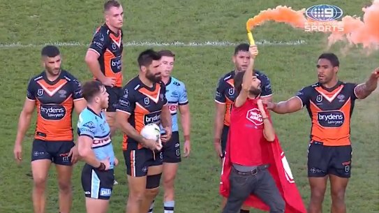 Screengrabs of fan with flare at Wests Tigers-Cronulla Sharks games