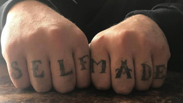 Sam Karagiotis has "self made" tattooed across his knuckles.