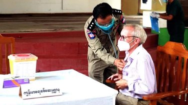 Sean Turnell is vaccinated against COVID in prison in Myanmar in this image released by the military.