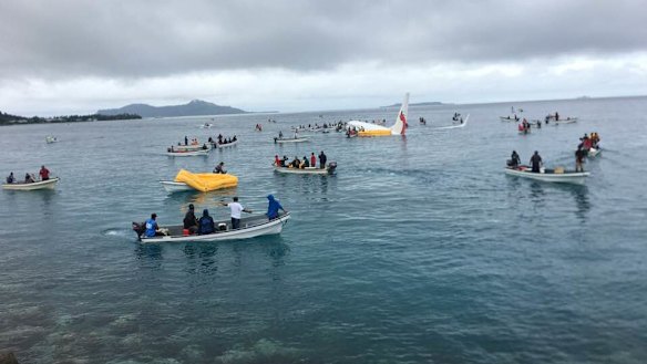 A number of locals in boats ferried passengers from the plane.