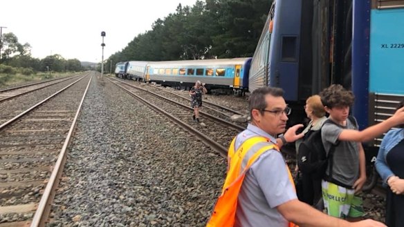 Passengers are helped off the train.