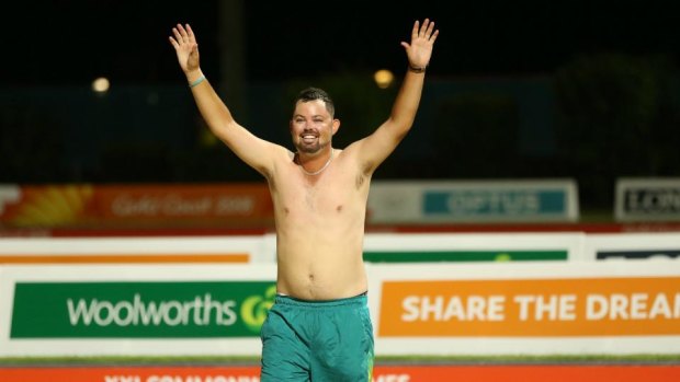 Aaron Wilson celebrates without a shirt on after his victory at the 2018 Commonwealth Games on the Gold Coast.