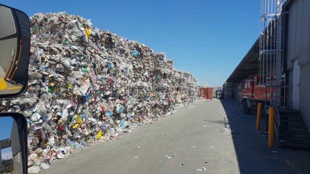 A wall of recycling material, photographed inside one of SKM's western Melbourne facilities the day before it was shut down by the EPA.