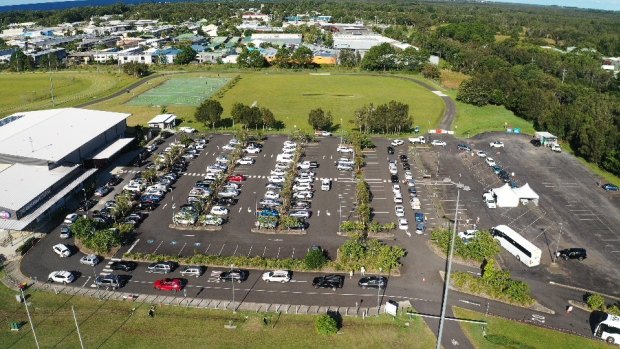 People wait in their parked cars to be tested for COVID-19 at Byron Bay.