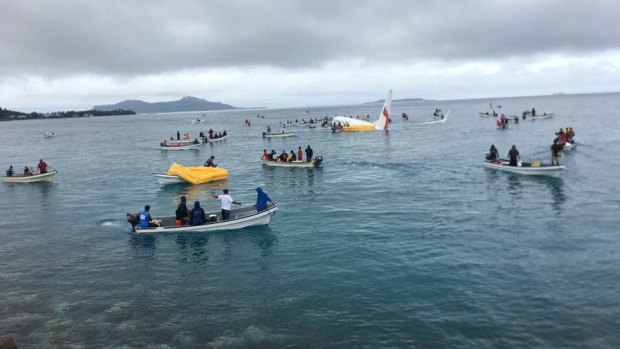 A number of locals in boats ferried passengers from the plane.