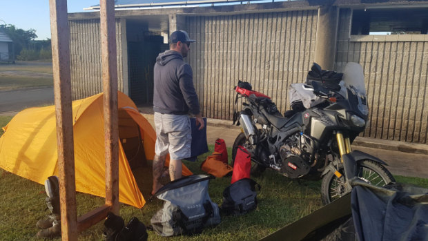 Daniel Price with the motorbike and camping gear he took on his trip from Kununurra to Karratha. 