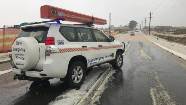 A SES vehicle drives through hail-coated roads in Sydney's west.