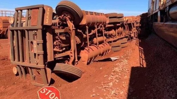 The truck was tipped on its side by the collision. 