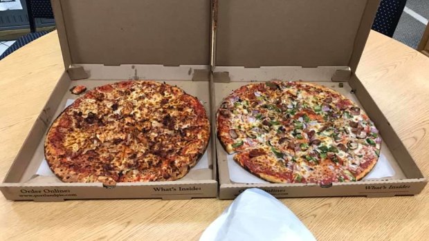 David Heady and Julie Lytle, air traffic controllers in Portland, Maine, were treated to pizza by Canadian air traffic controllers from Moncton Center. 