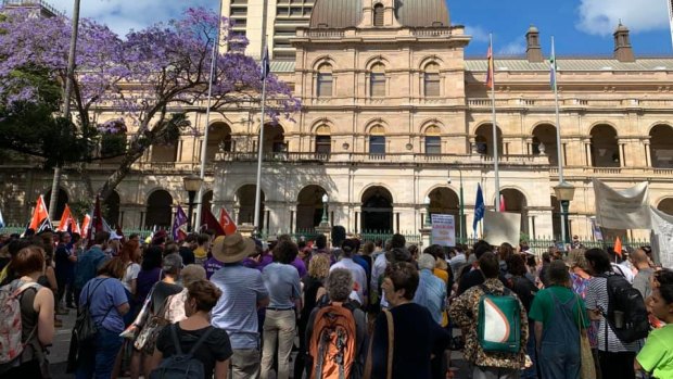People rally outside Parliament in Brisbane to rail against Queensland's proposed amendments to protest laws.
