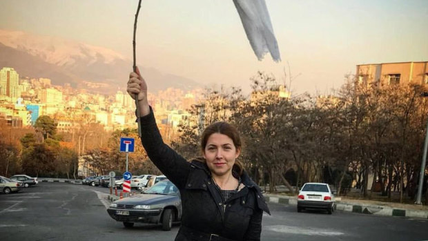 One of the women in Iran protesting by holding their veils aloft on sticks in late 2017 and 2018.