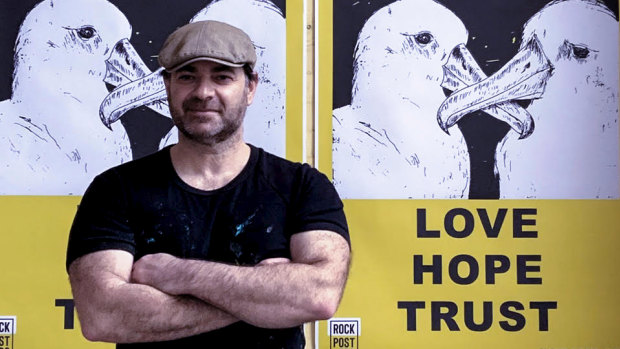 Melbourne artist Marco Luccio with his Love Hope Trust poster.