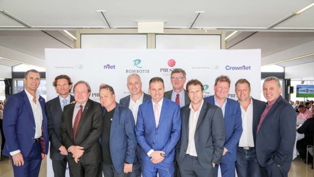 Paul Finn (fifth from left) with various AFL stars and identities.
