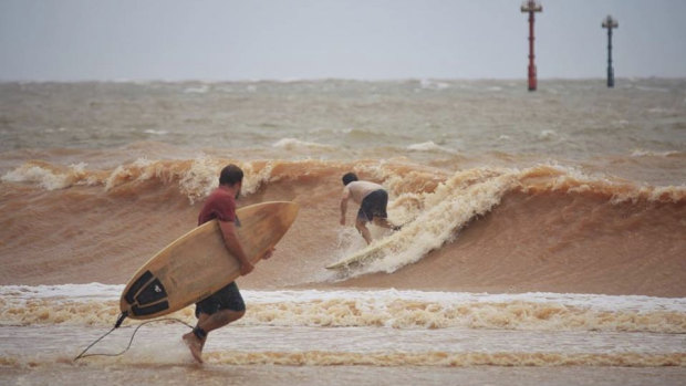 Surfers at Port Hedland make the most of the waves, as police warn residents to stay out of the ocean. 