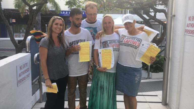 Renee Stewart, left, and fellow Justice for Captives protesters with their infringement notices.