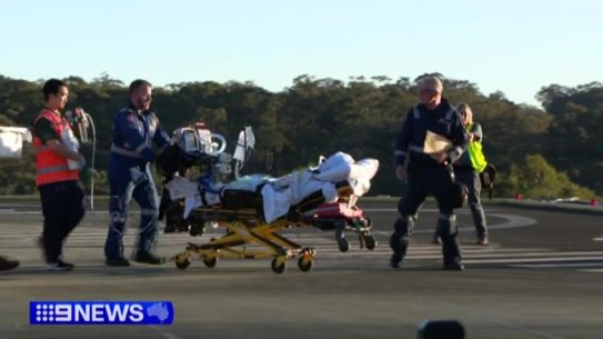 Emergency services care for Kai McKenzie after the attack.