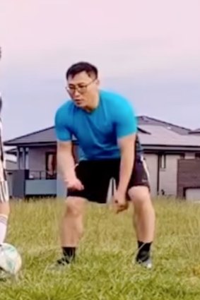 Kwang Kyung Yoo playing soccer with a child in 2022.