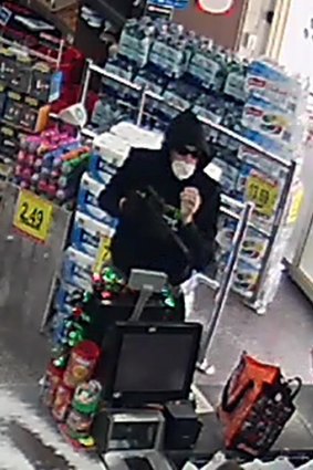 ACT Policing is looking for witnesses after a man (pictured) threatened customers and stole cash from a Nicholls supermarket on Saturday.
