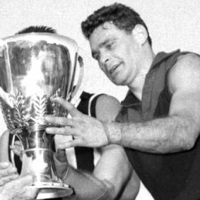 Melbourne captain Ron Barassi receives the 1964 premiership cup.