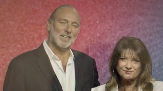 Brian Houston, flanked by his wife, Bobbie, tells the faithful on Sunday he is stepping down from all roles with the church as he prepares to defend court charges.