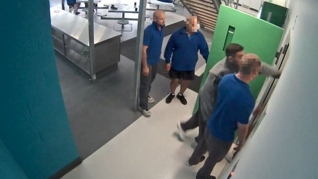 Marcus Rappel, far left, and Daniel Grech, throwing a punch, were sentenced for the Alexander Maconochie Centre assault.