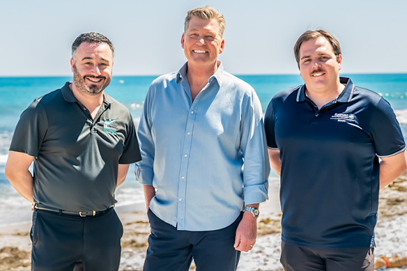9News Perth’s Michael Thomson, centre, with Rottnest Channel Swim Association executive director Addy Wetzler and president Will Rollo. 