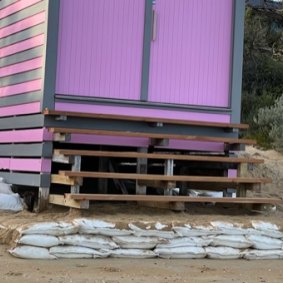 Sandbags around bathing boxes at Dendy Street beach.