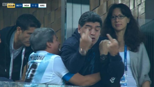 Classy: Maradona gives Nigeria fans the finger.