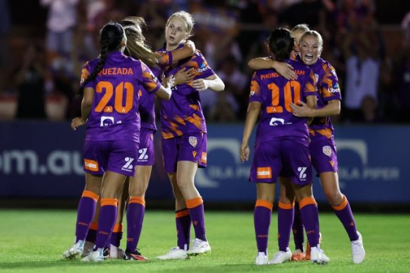 Glory players celebrate the win.