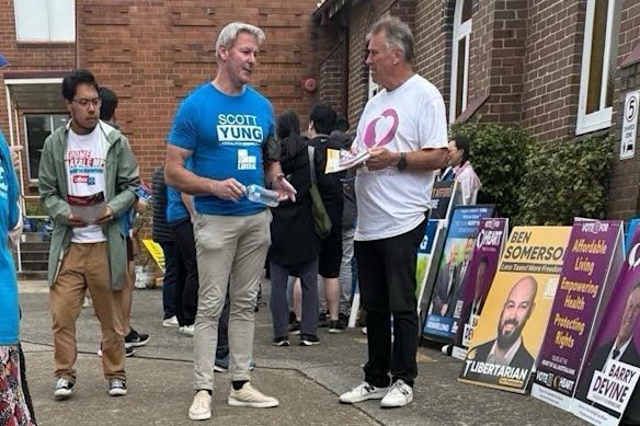 Gareth Hales (centre, in blue Scott Yung T-shirt), the son of the Brethren’s world leader, Bruce Hales, at the Bennelong polling booth in Sydney on April 30.