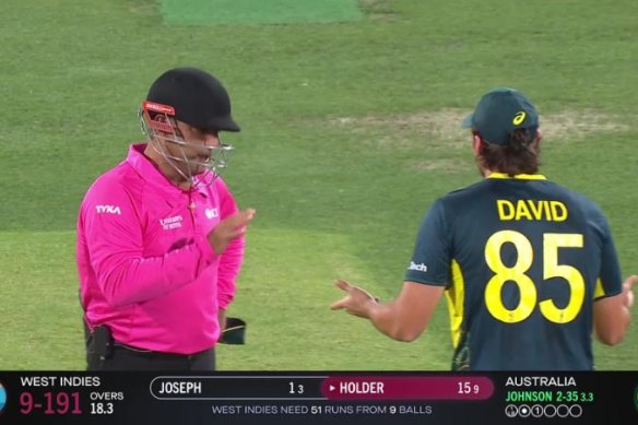 Umpire Gerard Abood informs Tim David there was no appeal for a runout of Alzarri Joseph.
