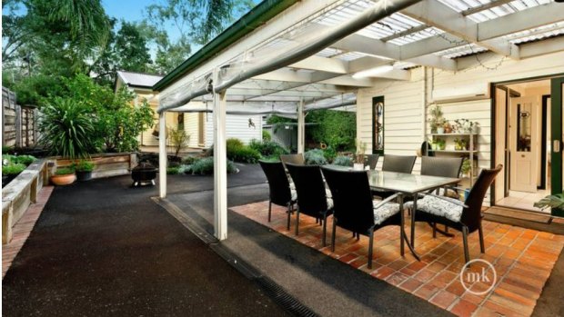 The large back yard includes an alfresco paved dining area and separate studio.