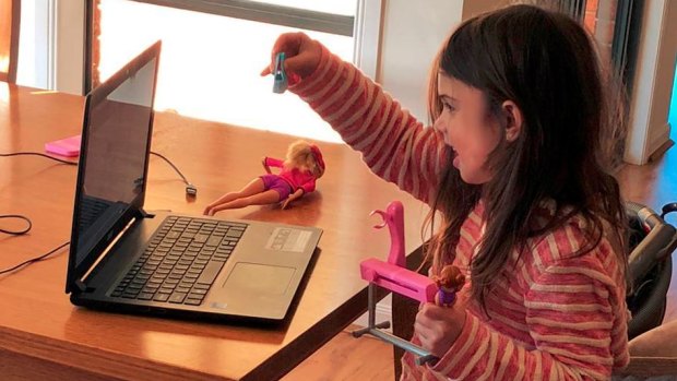 Sadie, 5, shows her dolls to her educator Phoebe Wong over Zoom. 