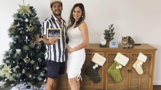 Three Christmas stockings were on display in the couple’s Alexandra Hills home, as Mr Field holds as ultrasound picture.