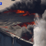 Exploding metal drums and toxic smoke burst from massive factory fire