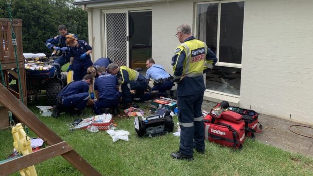 Paramedics treat a man injured in a quad bike accident at a home in Mount Hunter.