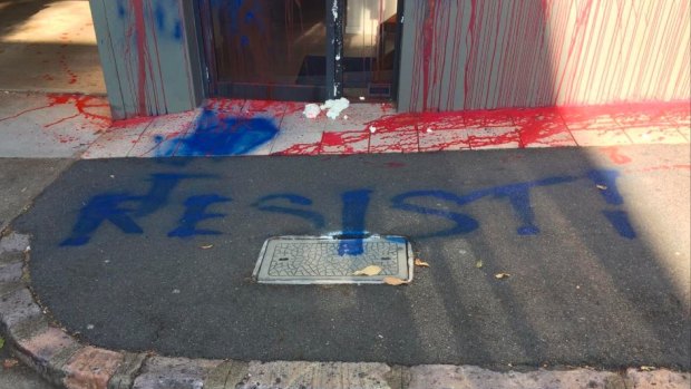 "Resist!" has been written in blue paint across the footpath in front of the LNP headquarters.