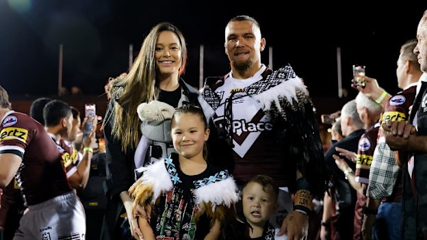 With his wife Natalie and their children.