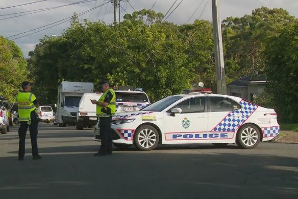 A man is fighting for his life while another is in custody after an alleged stabbing near a Brisbane school.