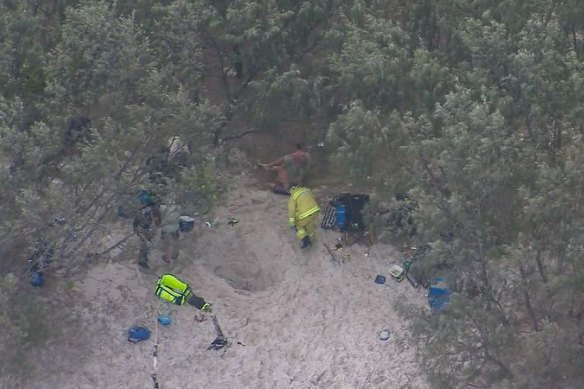 Paramedics told Nine News the friends dug a hole before Taylor fell into it head-first and became buried.