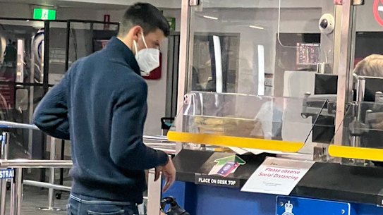 Novak Djokovic presents his travel papers after arriving at Melbourne Airport  on Wednesday evening.