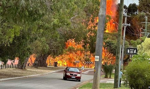 The fire is very close to homes.