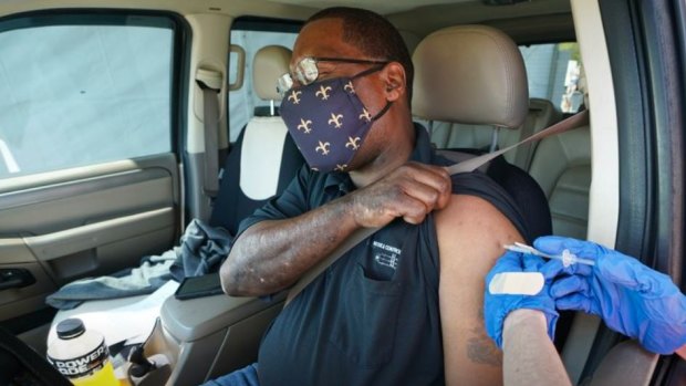 Brian Snipes receives a drive-thru vaccination at “Vaccine Fest,” a 24-hour COVID-19 mass vaccination event in Metairie, Louisiana. 
