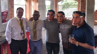 Embarrassing: Clive Eksteen and Altaaf Kazi posing with spectators wearing Sonny Bill Williams masks during the second Test.