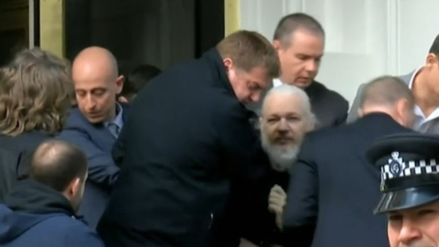 Julian Assange is arrested by British police on Thursday.