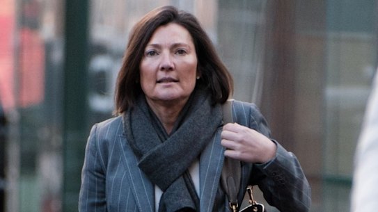 Helen Rosamond enters court on charges of defrauding NAB for millions of dollars through an invoice kickback scheme.
