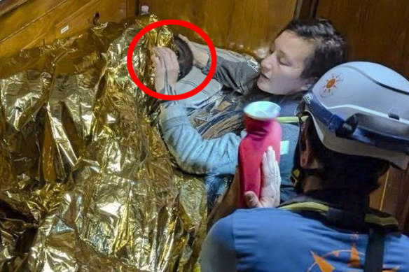 Rescuers attend to the 11-year-old girl from Sierra Leone (circled) who was found floating in the Mediterranean Sea.