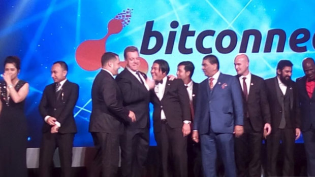 Bitcoin entrepreneur John Bigatton (fourth from left) at a BitConnect conference. 