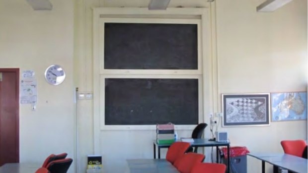 A blackboard remains in one of the classrooms in Block A.
