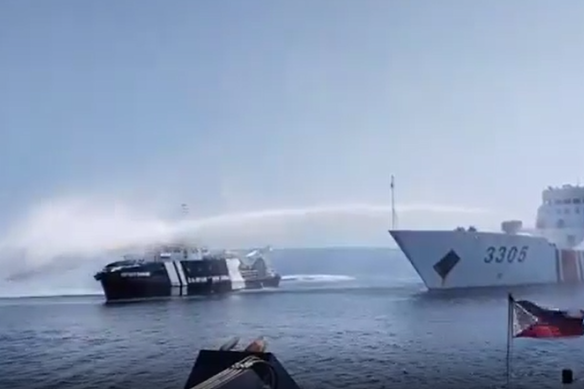 A Chinese ship fires water cannon at a Philippines vessel.
